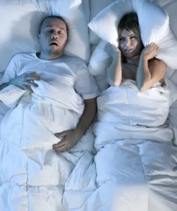 Man Snoring and Unhappy Woman
